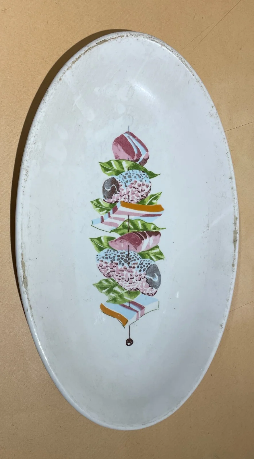 Cuisine: Oval Ceramic Dish with a Meat Skewer